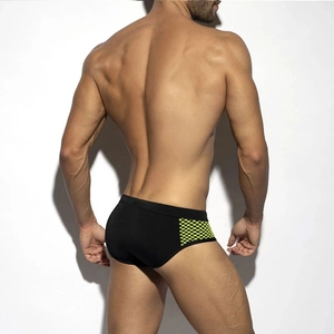 Rear view of men's low-rise swim briefs featuring black fabric and neon yellow mesh panel