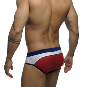 Rear view of men's low-rise red swim briefs with nautical navy trim and anchor print