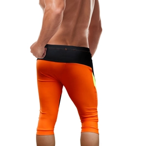 Detail view of the back seams and contrast color panels on men's sports swim leggings