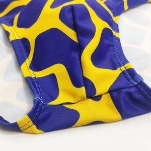Close-up of giraffe pattern swimwear showing the 3D contour pouch and elastic fabric