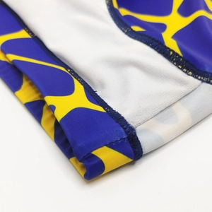 Detail of flatlock stitching on men's quick-dry swim briefs with blue and yellow print