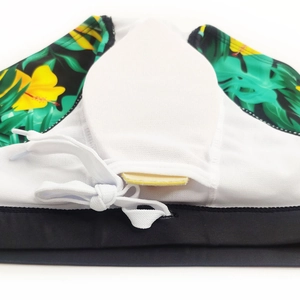 Detail of men's swim briefs showing tropical print, mesh lining and white drawstring