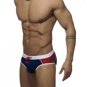 Detail of navy and burgundy patchwork swim briefs with white piping and red drawstring