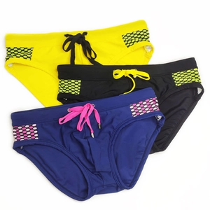 Detailed view of quick-dry men's swim briefs with honeycomb patterns and drawstring waist