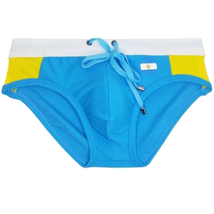 Detail of light blue men's swim briefs with yellow side panels and drawstring waist