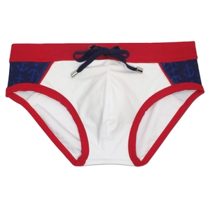 Detail of nautical men's swim briefs featuring navy anchor print and red contrast edges