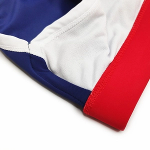 Detail view of quick-dry swim trunks featuring tricolor panels and white mesh lining
