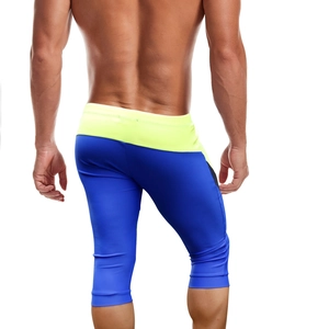 Rear view of quick-dry men's swim leggings featuring blue and yellow color block design