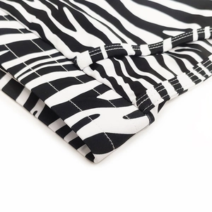 Detailed view of zebra print men's swim trunks with professional double-needle stitching
