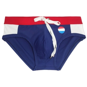 Detail of color-block swim briefs with red waistband, blue body, and white side panels