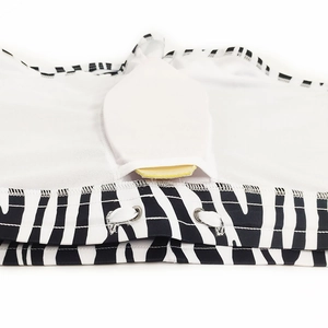 Detail of zebra stripe swim trunks with metal eyelets, drawstring, and contour padding