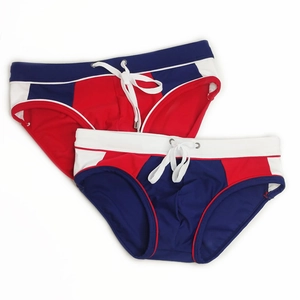 Detailed view of men's color-block swim briefs with elastic waist and white drawstrings
