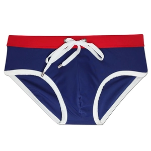 Detail of men's navy swim briefs with a red contrast waistband and adjustable white drawstring