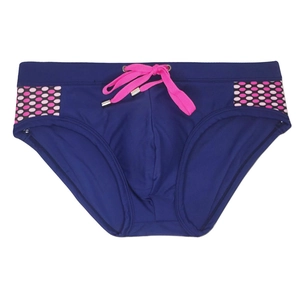 Detail view of navy blue swim briefs with bright pink drawstrings and polka dot side panels