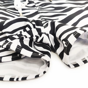 Detail of zebra stripe men's swim trunks featuring side pockets and adjustable waist drawstring