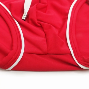 Detail of red men's swim briefs with white drawstring and silver metal tips