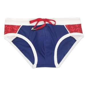 Detail of men's color-block swim briefs with red drawstring and anchor print pattern