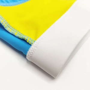 Close-up of tricolor stitching on blue, yellow, and white panel bikini swimwear