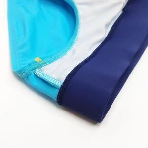 Dettaglio del tessuto blu elastico con ampia fascia blu scuro e fodera bianca morbida