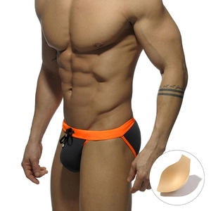 Detailed view of men's dark grey swim briefs with neon orange waistband and sponge pad