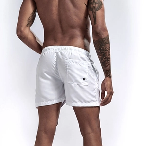 Detailed back view of white quick-dry beach shorts with elastic waist and buttoned pocket