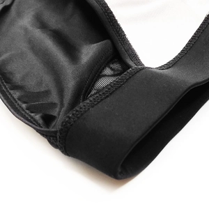 Close-up of black men's low-waist briefs featuring mesh paneling and reinforced stitching