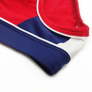 Detail of color-block men's swim briefs showing stitching and premium elastic fabric