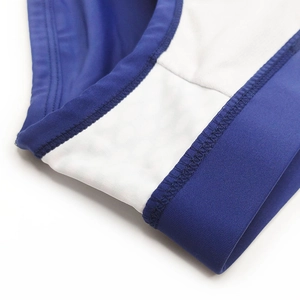 Detailed macro view of the double-stitched seam on high-elastic blue and white swimwear