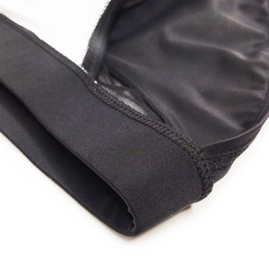 Detail of men's low-rise swim briefs featuring mesh fabric and elastic waistband texture