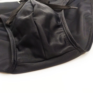 Detail of black swim briefs featuring an adjustable drawstring and a contoured pouch design