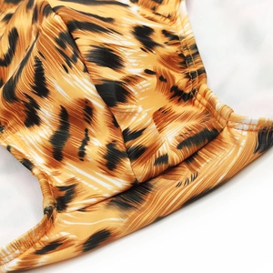 Close-up of sexy tiger print men's swim briefs showing elastic fabric and sewing detail
