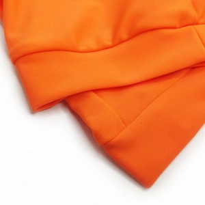 Close-up of orange sports swimwear featuring ribbed elastic cuffs and premium stitching
