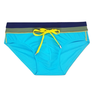 Detail of blue men's swim trunks with tricolor striped waistband and yellow drawstring