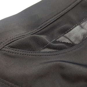 Detailed close-up of men's black swim briefs featuring breathable mesh stitching and fine seams