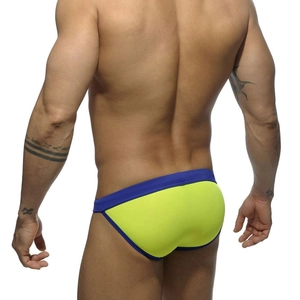 Rear view of men's neon yellow low-rise bikini swim briefs with navy blue contrast trim