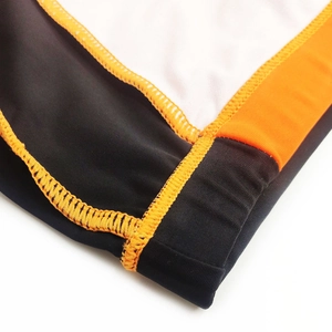 Detail view of contrast stitching and stretch fabric on men's athletic swimming trunks