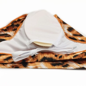 Detail of tiger print men's swim briefs with white lining and removable cup padding insert