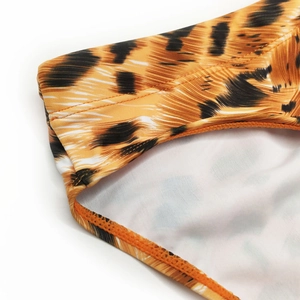 Detailed close-up of tiger print swim briefs featuring premium stitching and soft white lining