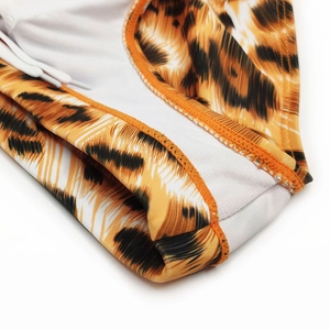Detail of tiger print swim briefs featuring elastic waist with adjustable white drawstring