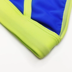 Detail of blue men's swim briefs with lime green trim and double-needle stitching