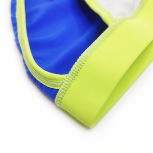 Detailed macro view of royal blue and neon yellow contrast stitching on men swim briefs