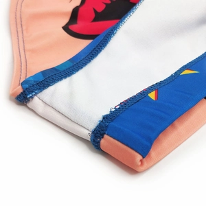 Macro view of flatlock stitching and vibrant geometric print on men's swim trunks