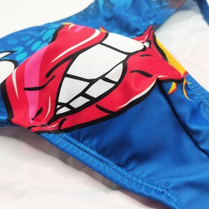Close-up of bright blue swimwear with red lips print and professional double stitching