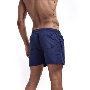 Detail of navy blue quick-dry swim trunks featuring back pocket and elastic drawstring waist