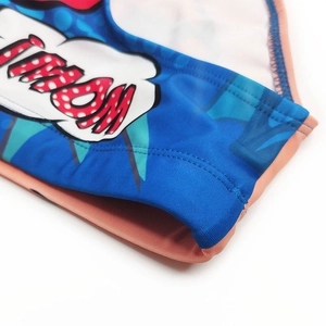Close-up of comic print swimwear fabric with durable double-needle stitching detail