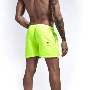 Men's neon green quick-dry beach shorts featuring elastic waistband and back pocket drainage hole