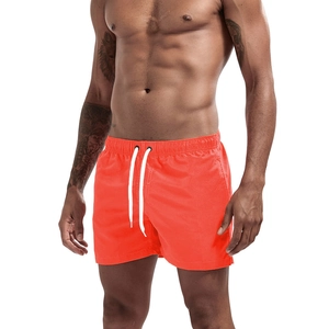 Men's neon orange quick-dry running shorts with elastic waist and white drawstring