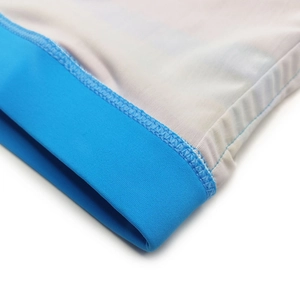 Detailed macro view of reinforced blue stitching and elastic mesh fabric on swim shorts