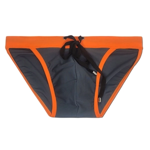 Detailed view of men's swim briefs with contrast orange stitching and metal eyelets
