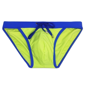 Flat lay of men's high cut swim briefs with neon green color block and drawstring